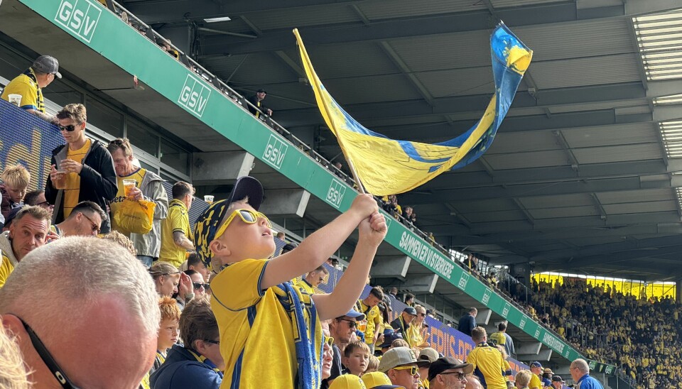 A young Brøndby fan waving his team’s flag as Brønby vs FCK kick off.