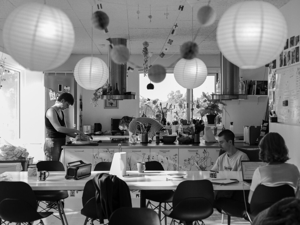 Four people in a kitchen.