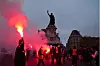 CGT protesters light red flares by Place de la Republique, a common arena for protests in Paris.