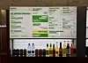 A green-and-white burger menu hangs above a row of bottled drinks.