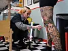 Tattoo artist Matilde works on Gitte’s heavily tattooed leg in an Aarhus studio.